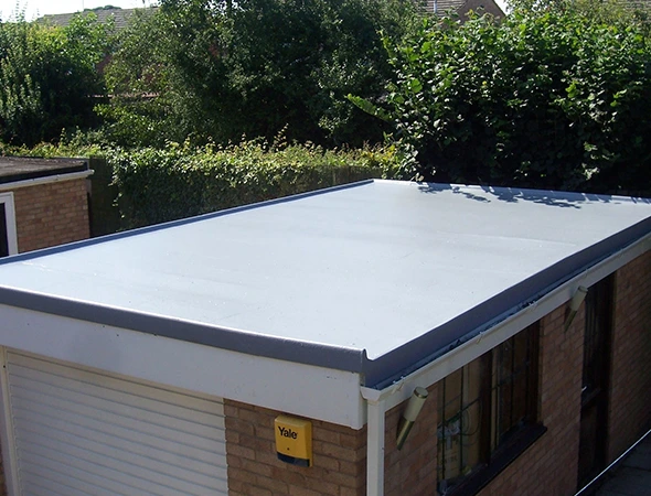 Newly installed flat roof on a garage, showcasing a clean and modern Flat Roof Installation.