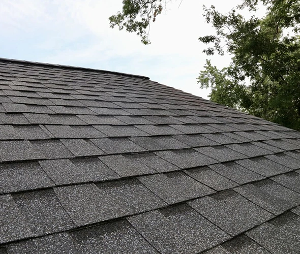 shingle roof installation featuring gray asphalt shingles on a home.